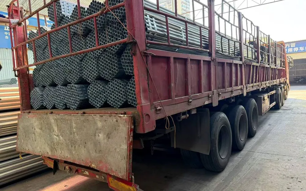 Galvanized corrugated steel sheets stacked on wooden pallets